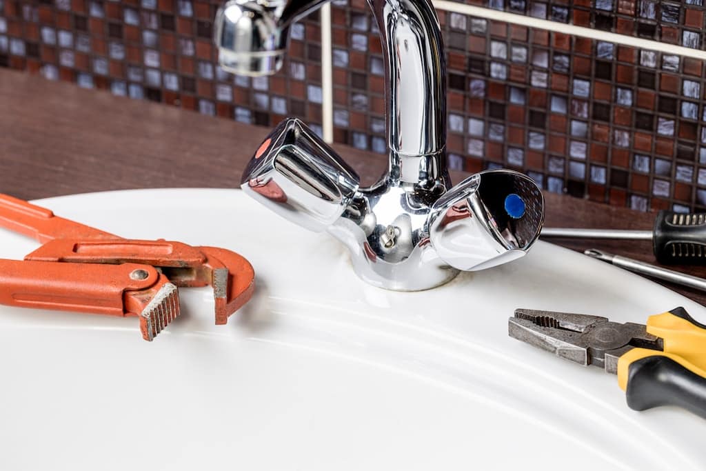 Bathroom plumbing faucet with tools from bathroom plumber.