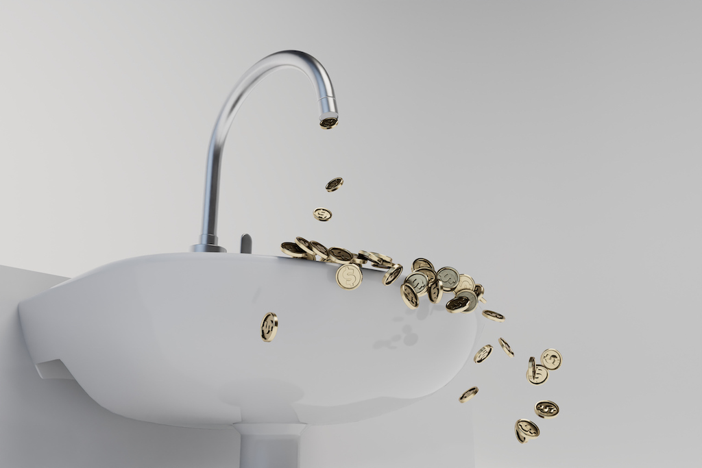 Coins falling out of bathroom faucet representing money spent and when you need a bathroom plumber.
