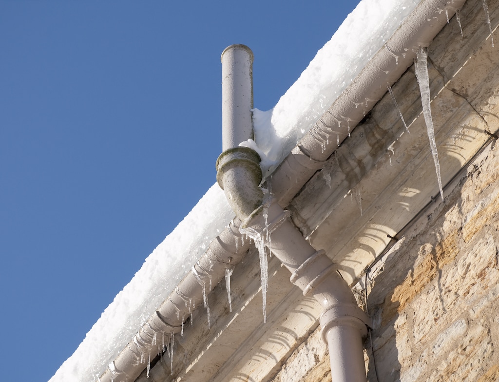 Frozen pipe on the side of an older home. Winter Plumbing Tips.