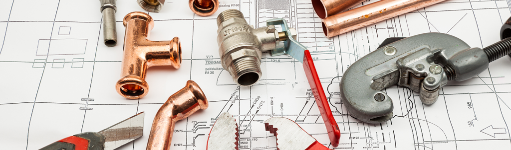 Plumbing tools laying on houseplans | Our Comprehensive Plumbing Services in Richardson, TX