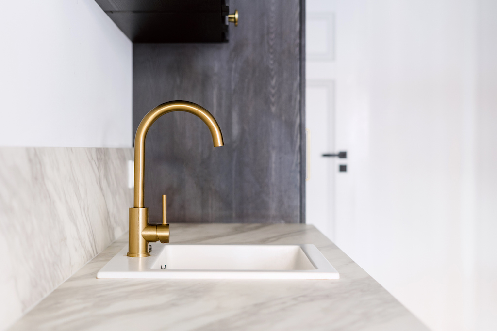 Brass faucet on modern sink. | Plumbing Service