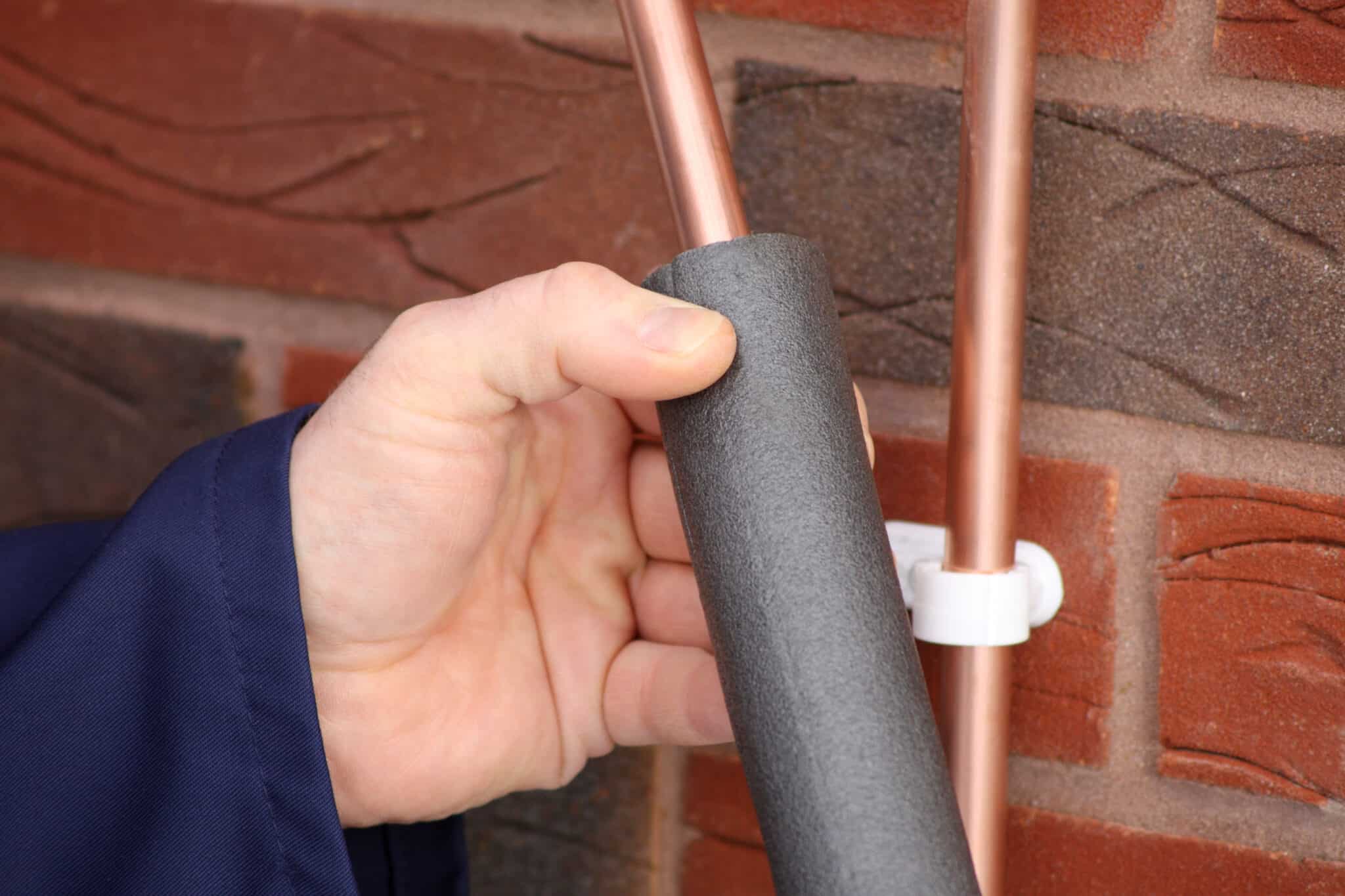 Plumber insulating a copper water pipe, Plumbing Tips.
