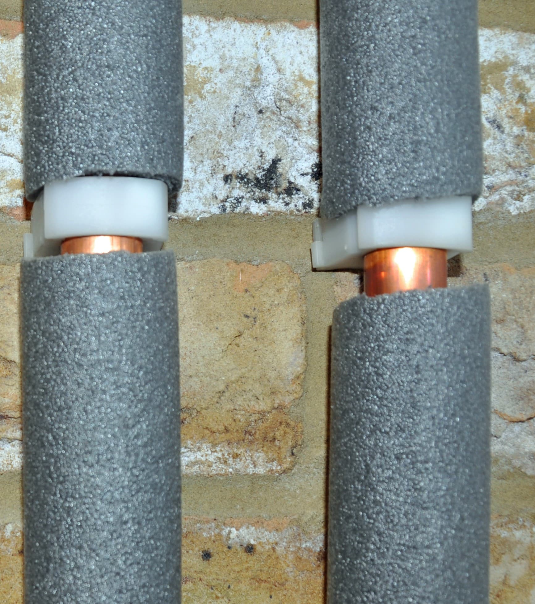 Copper water pipes in grey foam insulation, Leak Prevention.
