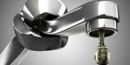 Leaky, worn faucet with water droplet highlighting faucet replacement cost myths and misconceptions.