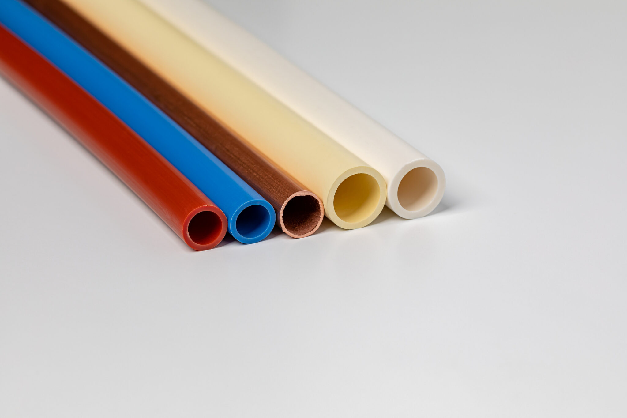 PVC, CPVC, PEX, and copper whole home repipe materials on a white background.