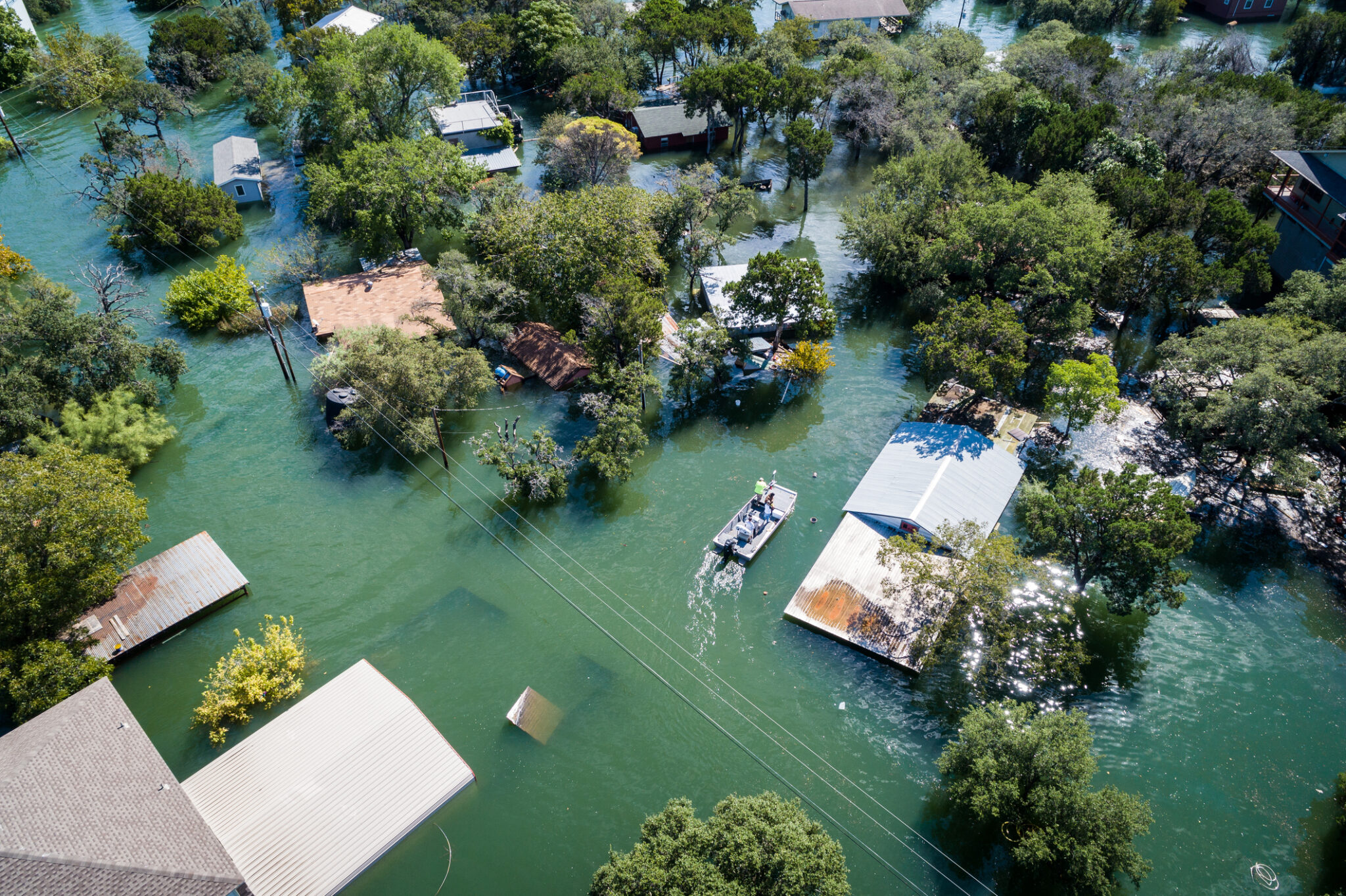 Aerial drone view of flooding illustrating why a sump pump check valve matters during heavy rain.